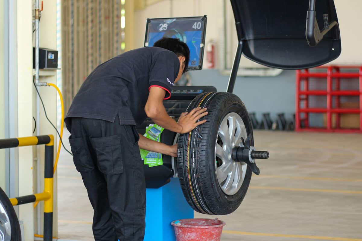 Mechanic checking the wheel alignment