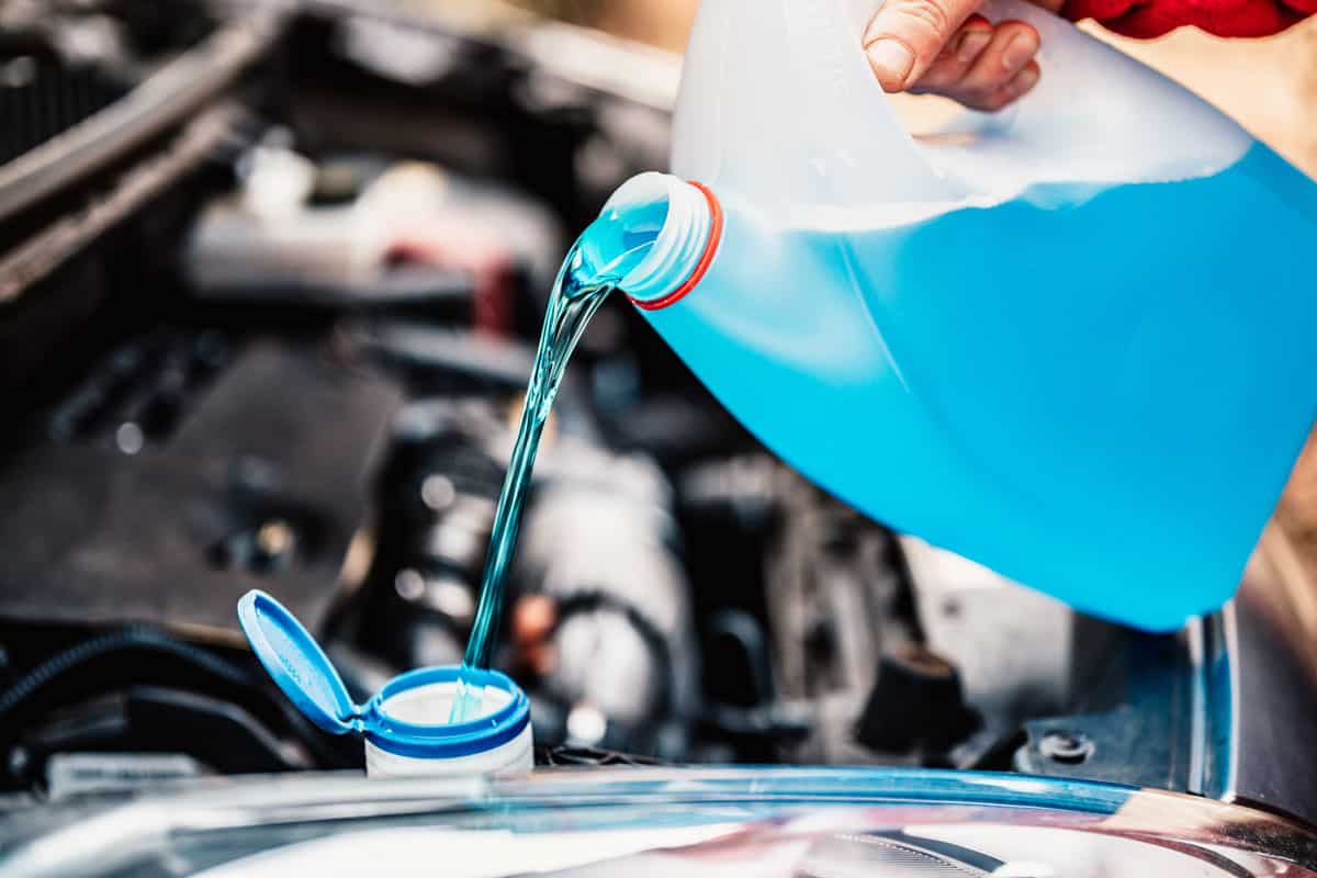 Pouring anti freeze to a car coolant reservoir