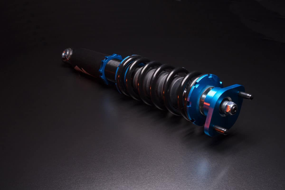 An up close photo of a coilover on a dark background