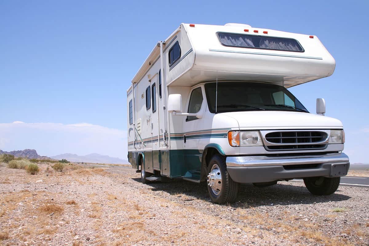 An RV parked on the camping grounds of a desert