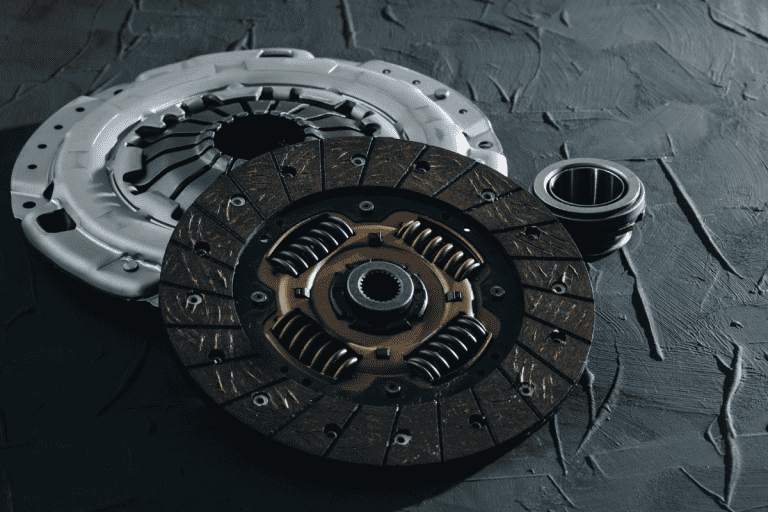 Automotive clutch mechanism, disc, basket and bearing for auto on a black background, The Ultimate Guide to Clutch Replacement: How Long Does It Really Take?