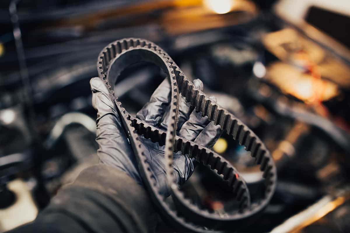 Automotive timing belt in the hand of an auto mechanic