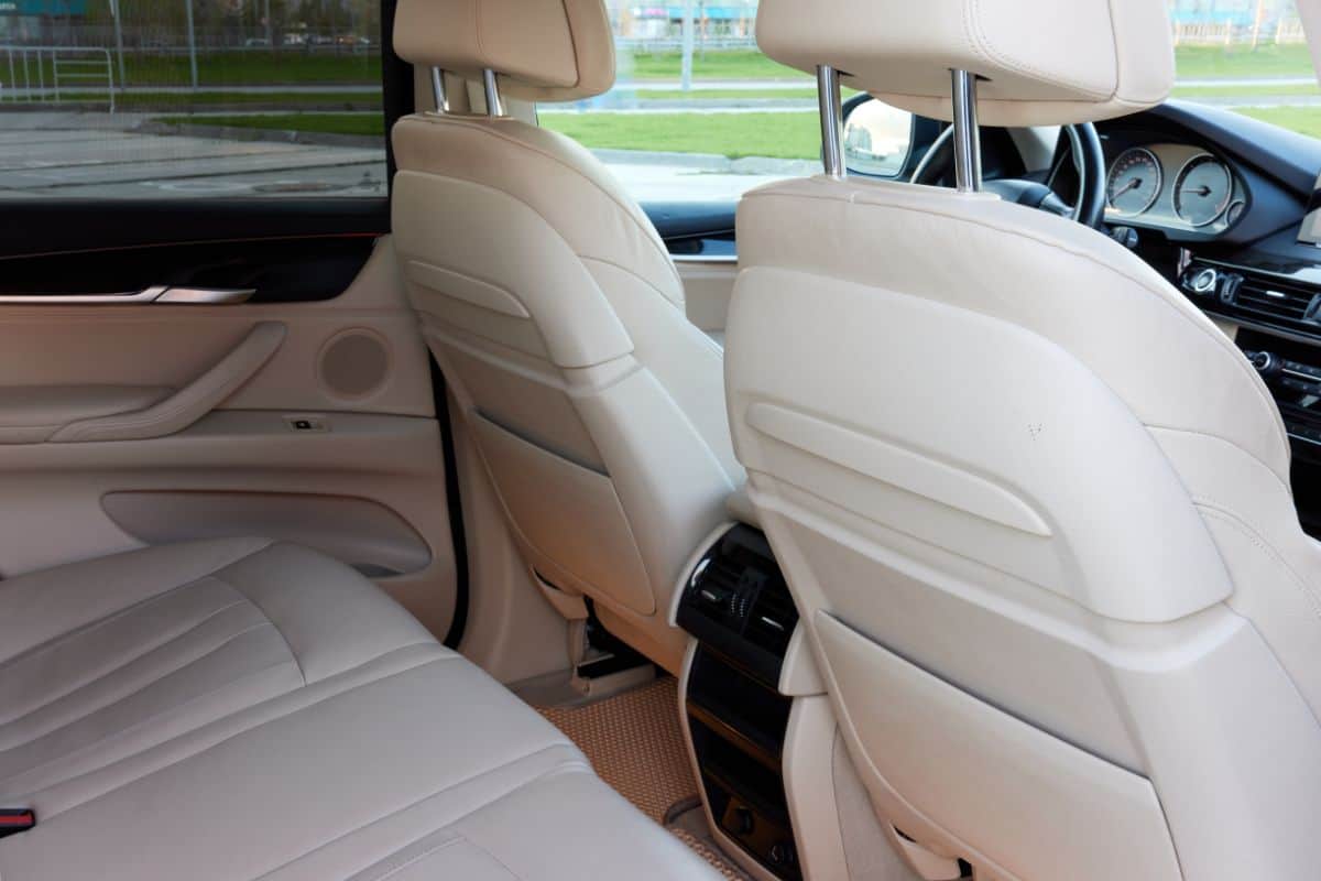BMW X5 steering wheel and dashboard. Beige leather car interior.