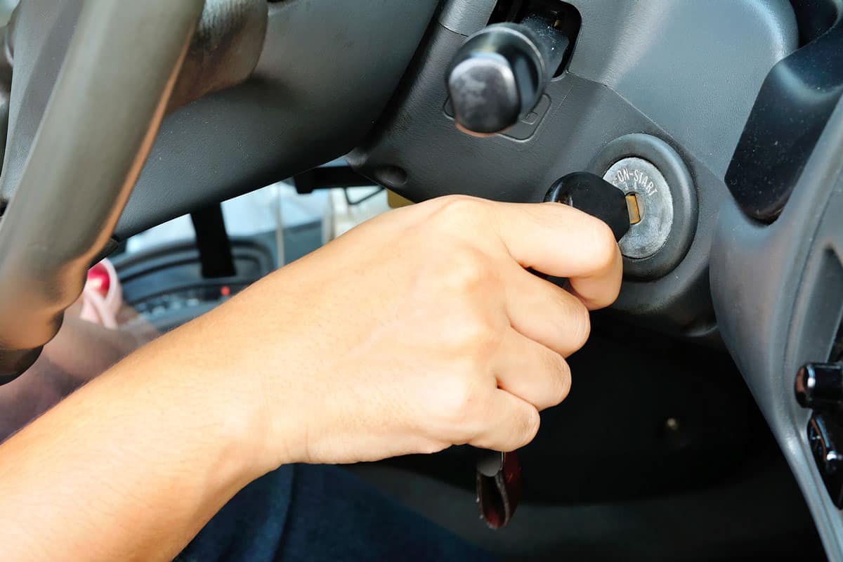 Car owner turning the key to turn the car on