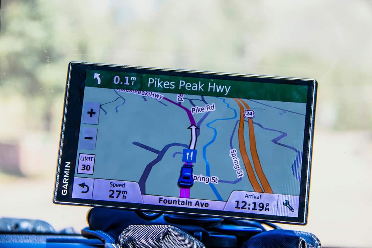 Garmin GPS sitting on dash of car showing road to Pikes Peak