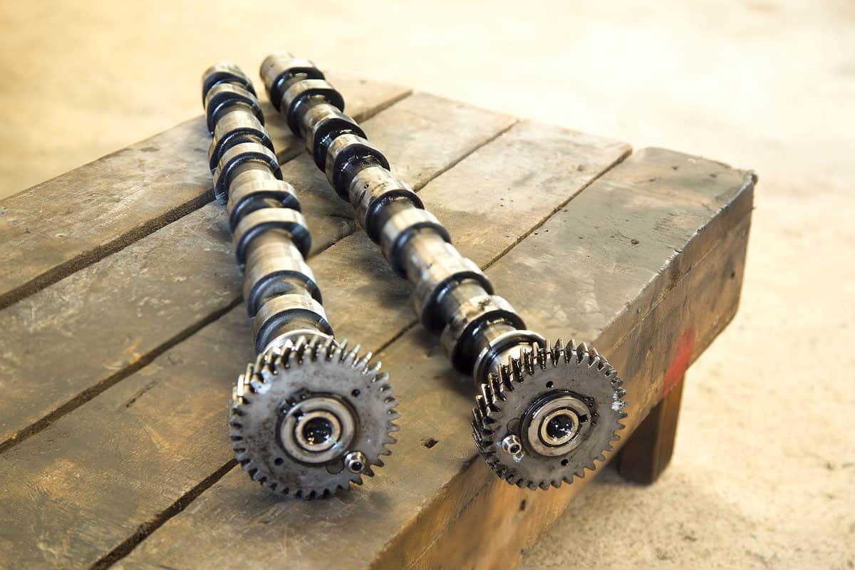 Two pairs of camshaft on a mechanics table