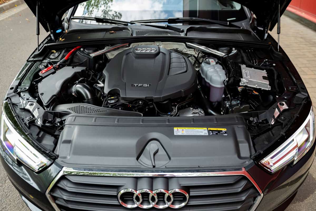 An Audi A4 with an opened hood showing the engine