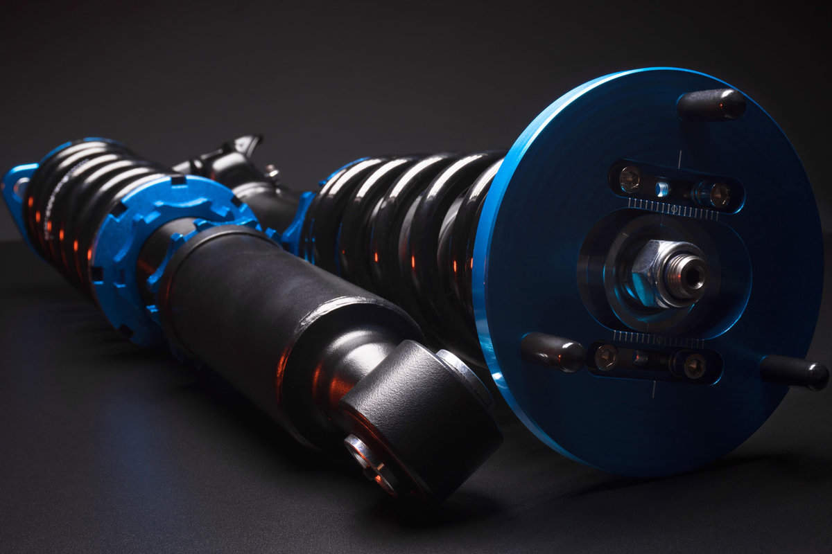 Blue coilovers, shock absorbers, and springs for both Dual and Quad Rivian car models, optimizing auto suspension tuning.