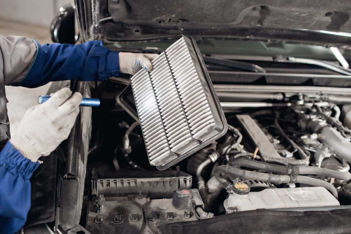 Car mechanic symptoms analysis part air filter of engine for maintaining isolated on white background with clipping path
