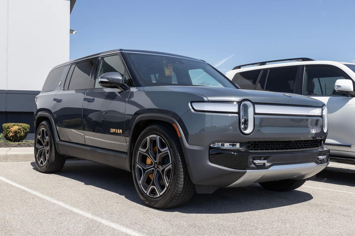 Rivian R1S electric SUV showcased at a dealership.