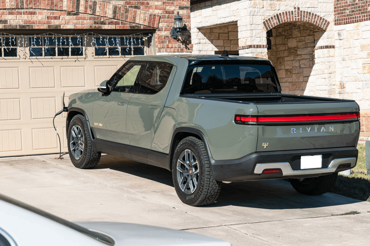 The dual-motor Rivian All Electric Pick Up Truck, donning a captivating forest green shade, presents an ideal choice for exhilarating adventures while embracing a renewable and sustainable lifestyle.