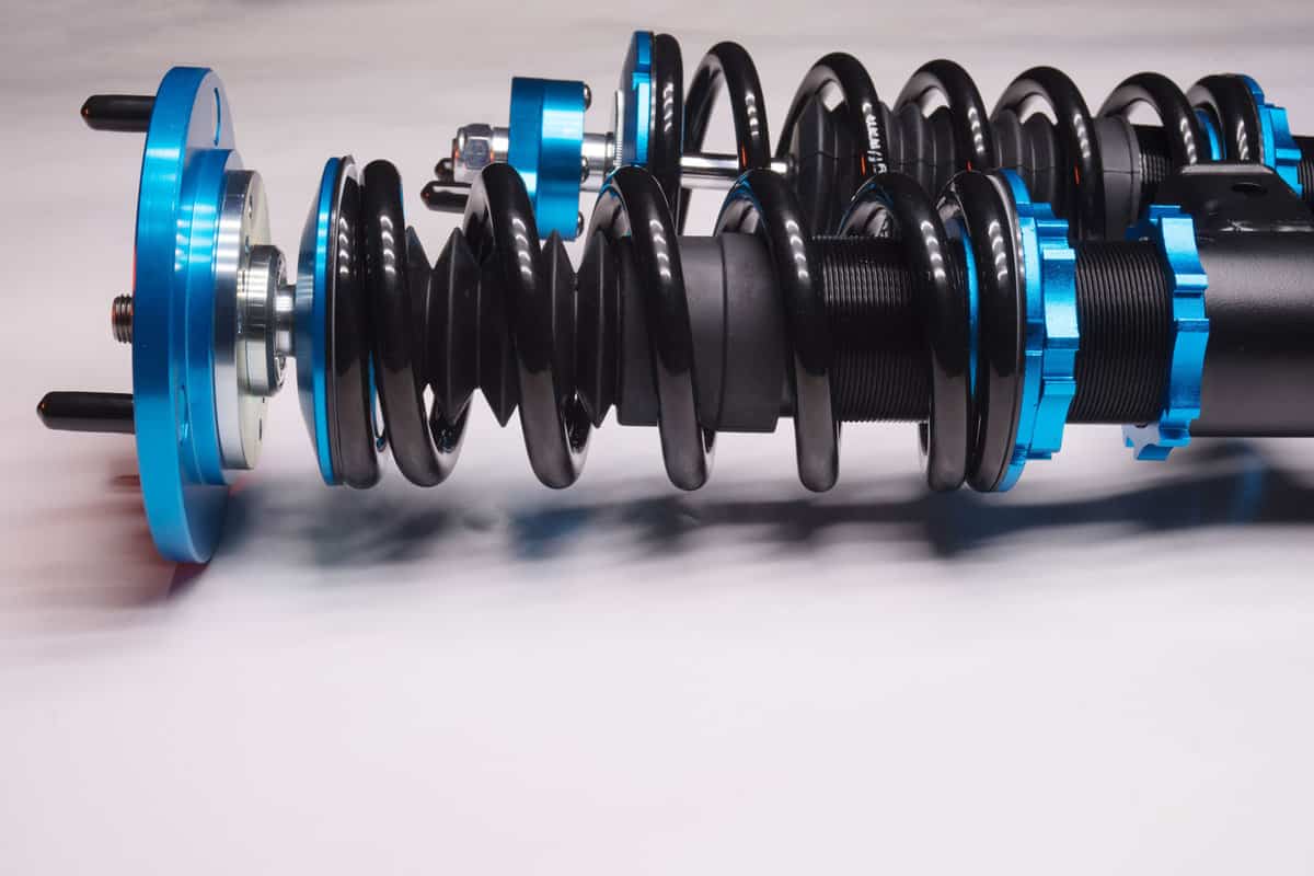 auto suspension tuning coilovers shock absorbers and springs blue for a sports drift car on a white background
