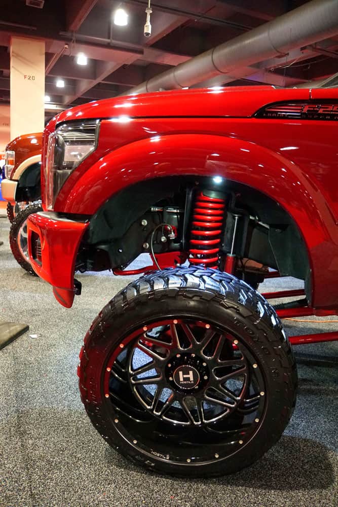 A huge red F 150 with a huge red painted lift kit