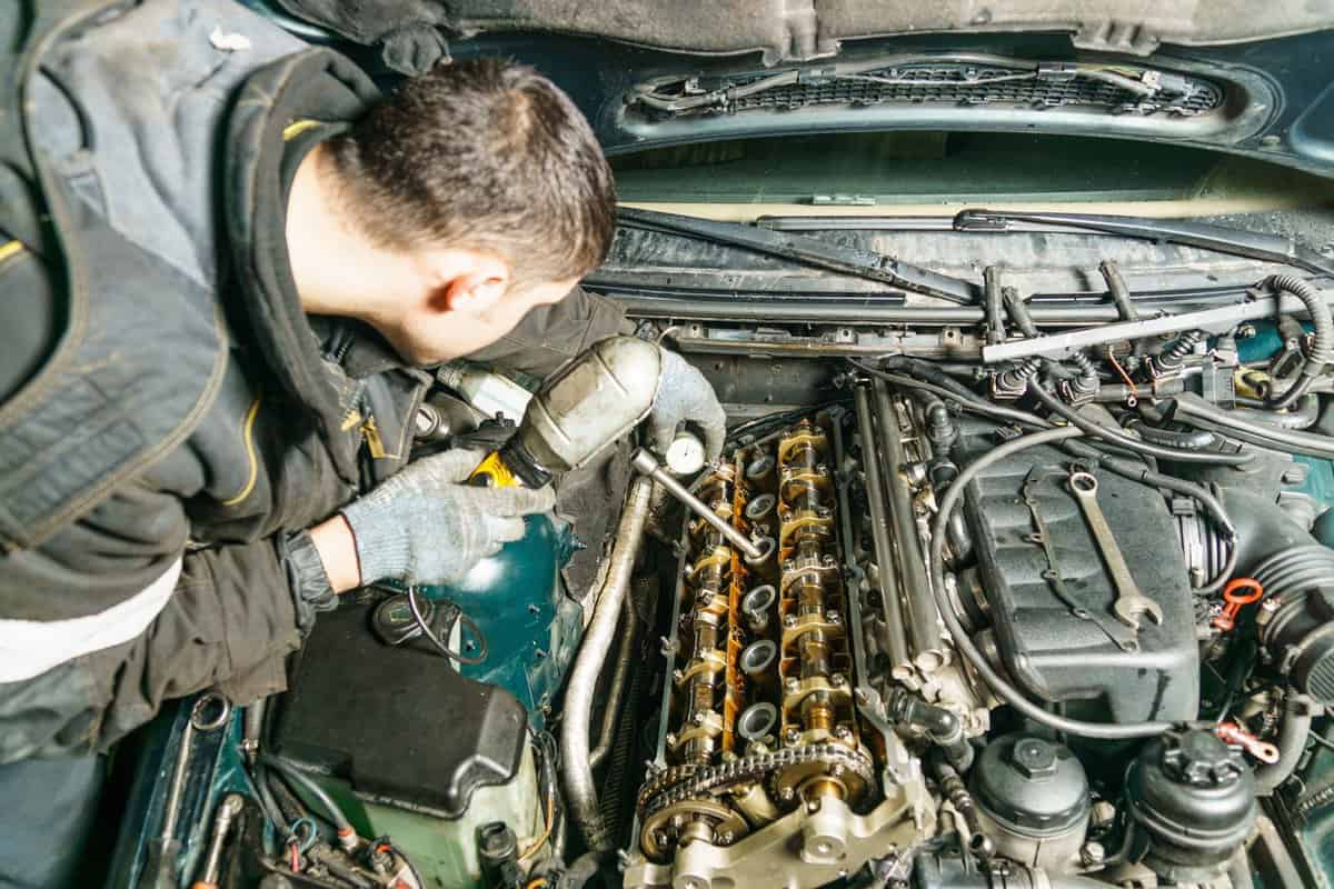 Mechanic checking the camshaft of a car engine