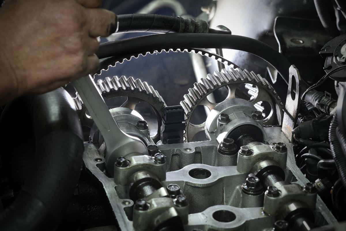 Mechanic using a wrench to adjust the camshaft