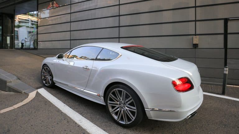 A white Bentley parked on the side of the building, How to Put Bentley in Jack Mode: a Step-by-Step Guide - 1600x900