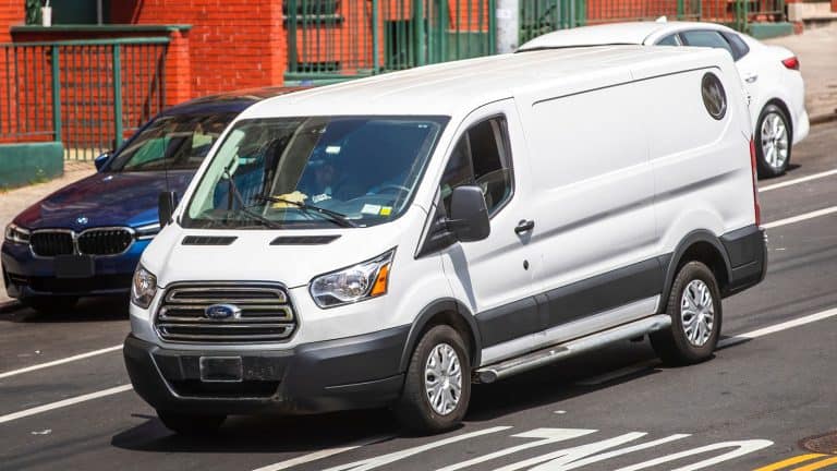 A white Ford Transit Connect moving on the busy New York streets, My Ford Transit Connect Keeps Going Into Limp Mode - Here's What You Need To Know - 1600x900