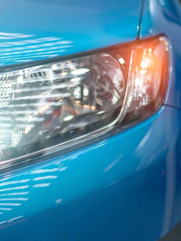 Blue modern car closeup of headlight